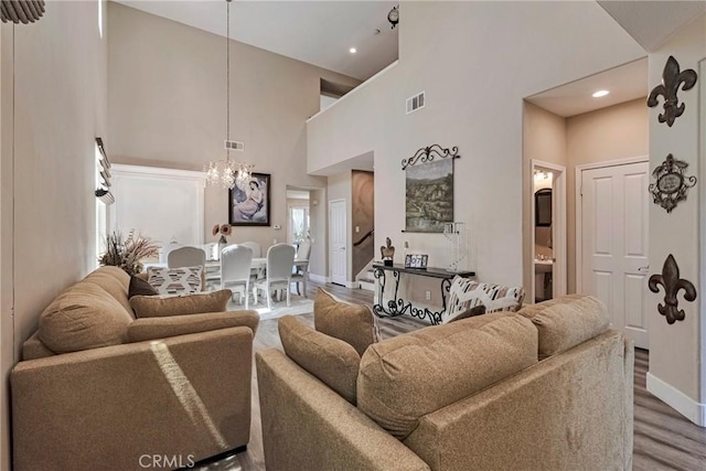 19639 Ellis Henry Ct, Newhall, CA 91321 - living area with a towering ceiling, a chandelier, wood finished floors, and recessed lighting
