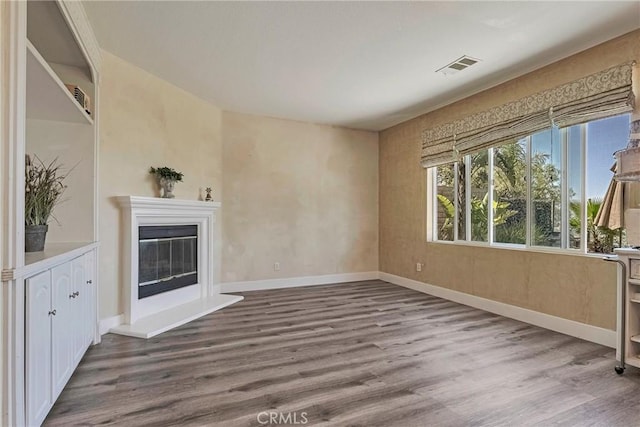 19639 Ellis Henry Ct, Newhall, CA 91321 - unfurnished living room with wood finished floors and a glass covered fireplace