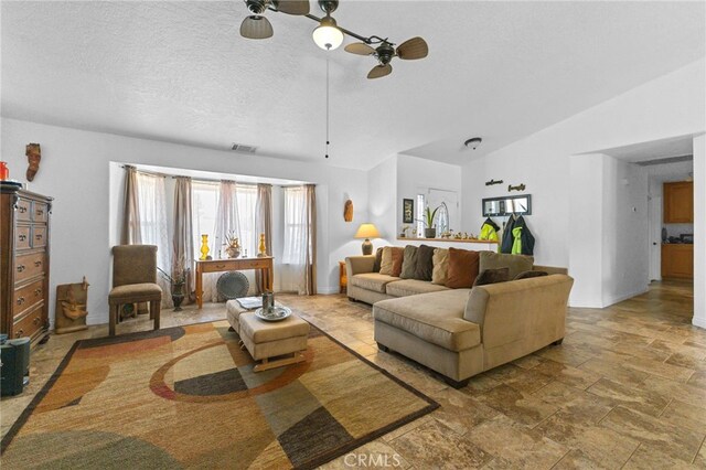 21130 Pine Ridge Ave, Apple Valley, CA 92307 - living area featuring ceiling fan, stone finish floors, lofted ceiling, and a textured ceiling