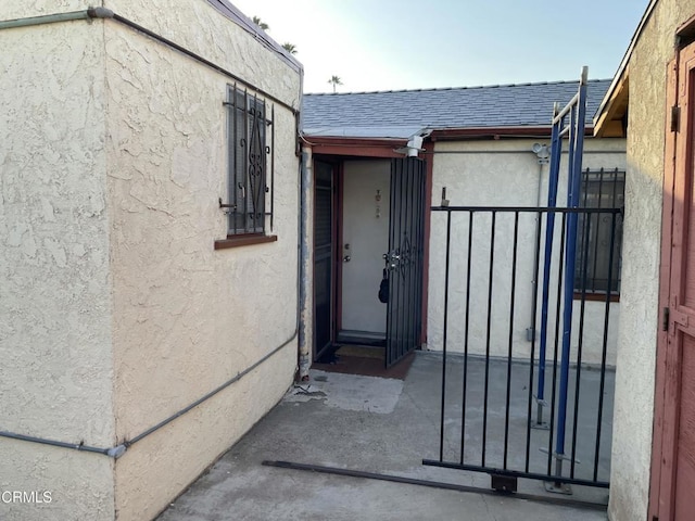 3833 Seneca Ave, Los Angeles, CA 90039 - property entrance with stucco siding, roof with shingles, and a gate