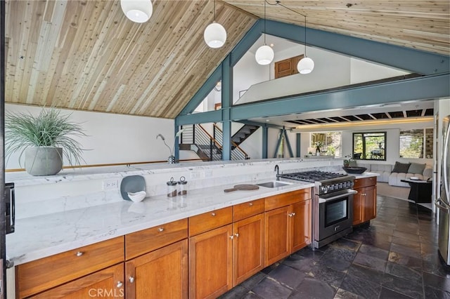 686 Diamond St, Laguna Beach, CA 92651 - kitchen with stainless steel appliances, lofted ceiling, brown cabinetry, dark stone finish flooring, and decorative light fixtures