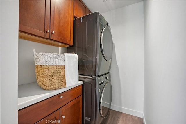 686 Diamond St, Laguna Beach, CA 92651 - laundry area with cabinet space, stacked washer and clothes dryer, and wood finished floors