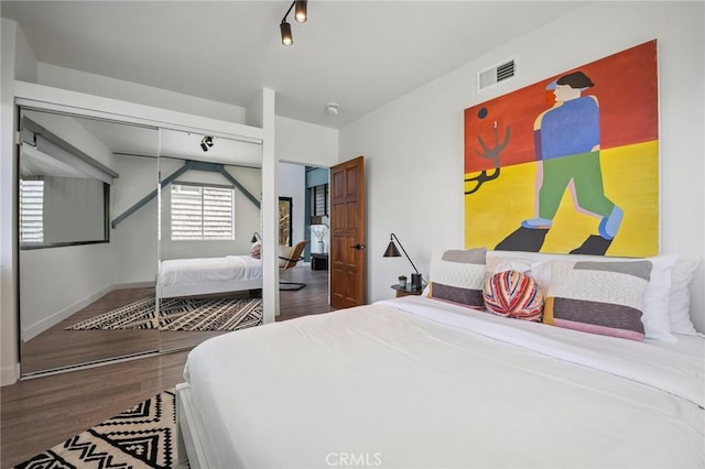 686 Diamond St, Laguna Beach, CA 92651 - bedroom featuring a closet, wood finished floors, and track lighting