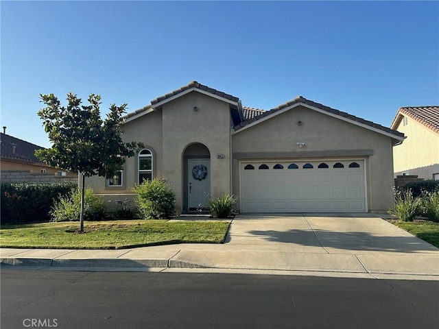 28433 Oasis View Cir, Menifee, CA 92584 - mediterranean / spanish-style house with a garage, stucco siding, driveway, a tile roof, and a front lawn