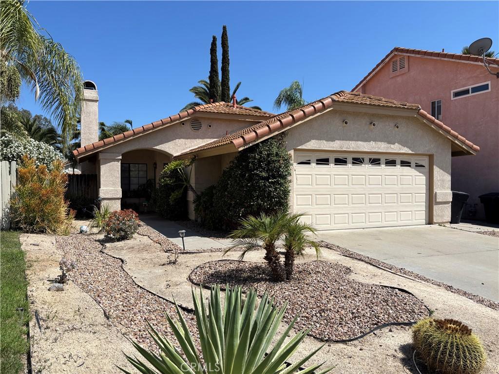 39830 Creative Dr, Temecula, CA 92591 - mediterranean / spanish-style home featuring a chimney, an attached garage, stucco siding, concrete driveway, and a tile roof
