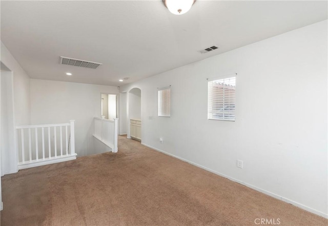1182 Chenin Blanc Cir, Perris, CA 92571 - empty room with carpet, arched walkways, and recessed lighting