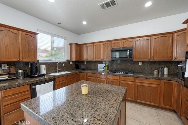 1182 Chenin Blanc Cir, Perris, CA 92571 - kitchen with appliances with stainless steel finishes, decorative backsplash, brown cabinetry, light tile patterned flooring, and recessed lighting