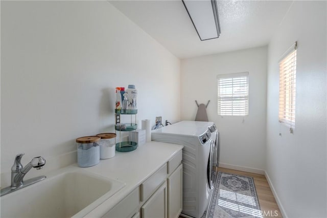 1182 Chenin Blanc Cir, Perris, CA 92571 - laundry area featuring cabinet space, washer and dryer, and light wood-style floors