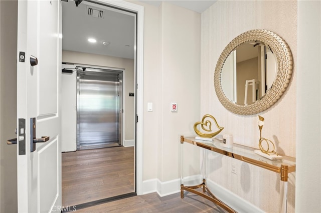 23500 Park Sorrento Unit H32, Calabasas, CA 91302 - corridor with elevator and dark wood finished floors