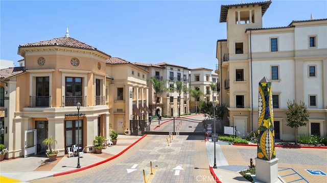23500 Park Sorrento Unit H32, Calabasas, CA 91302 - view of street featuring curbs, street lighting, a residential view, sidewalks, and a gate