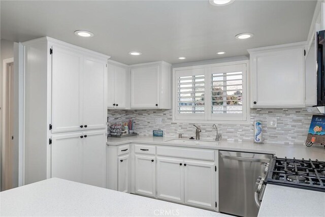 309 Sequoia St Unit 3, Morro Bay, CA 93442 - kitchen featuring stainless steel dishwasher, light countertops, white cabinetry, backsplash, and recessed lighting