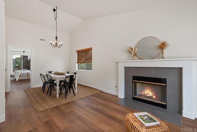 2663 Sutter St, Carlsbad, CA 92010 - dining room featuring lofted ceiling, wood finished floors, a chandelier, and a tile fireplace