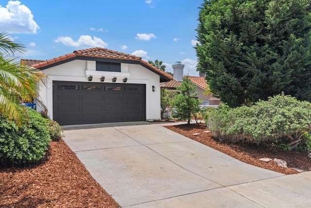 2663 Sutter St, Carlsbad, CA 92010 - mediterranean / spanish house with concrete driveway, an attached garage, a tiled roof, and stucco siding