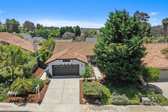 2663 Sutter St, Carlsbad, CA 92010 - mediterranean / spanish house with a tile roof, driveway, an attached garage, and stucco siding