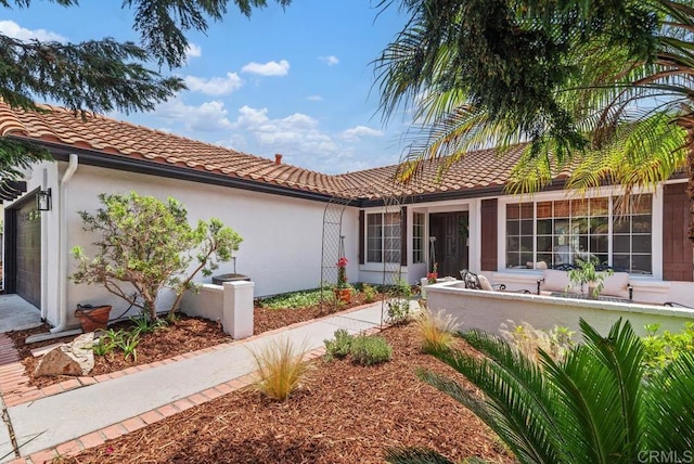 2663 Sutter St, Carlsbad, CA 92010 - mediterranean / spanish house featuring an attached garage, a tiled roof, and stucco siding