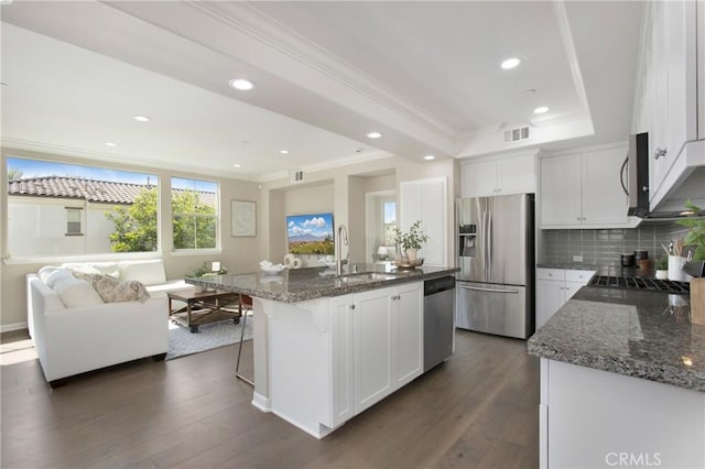 402 Maravilla Ln, Brea, CA 92823 - kitchen with stainless steel appliances, crown molding, tasteful backsplash, a raised ceiling, and white cabinetry