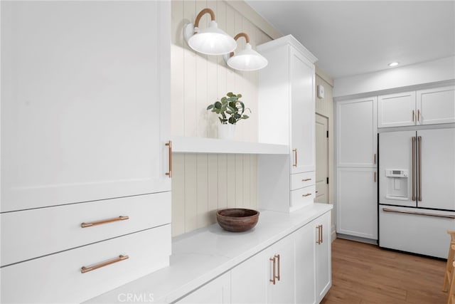 16229 Orizaba Ave, Paramount, CA 90723 - kitchen with high end white refrigerator, white cabinets, light wood-style floors, recessed lighting, and pendant lighting
