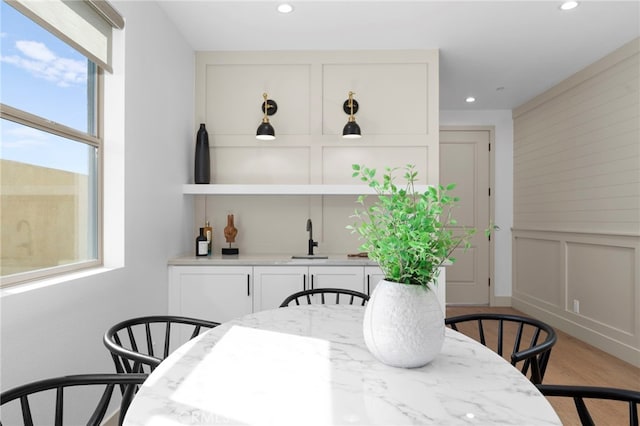16229 Orizaba Ave, Paramount, CA 90723 - dining space with bar area, wood finished floors, a decorative wall, and recessed lighting