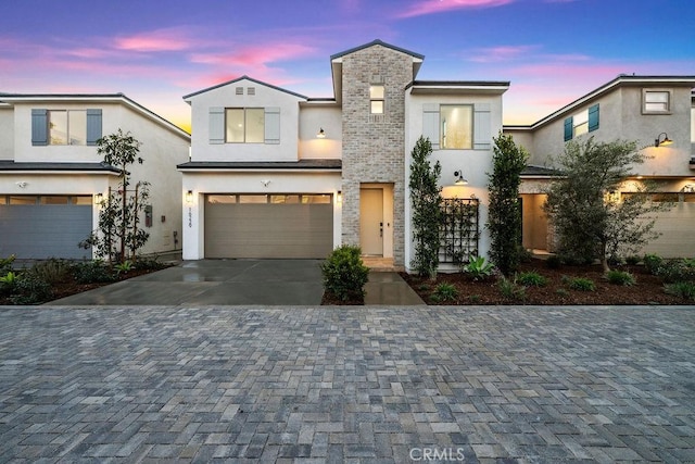 16229 Orizaba Ave, Paramount, CA 90723 - modern home featuring stucco siding, decorative driveway, and a garage