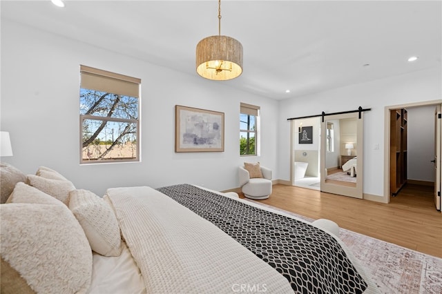 16229 Orizaba Ave, Paramount, CA 90723 - bedroom featuring a barn door, recessed lighting, and light wood-type flooring