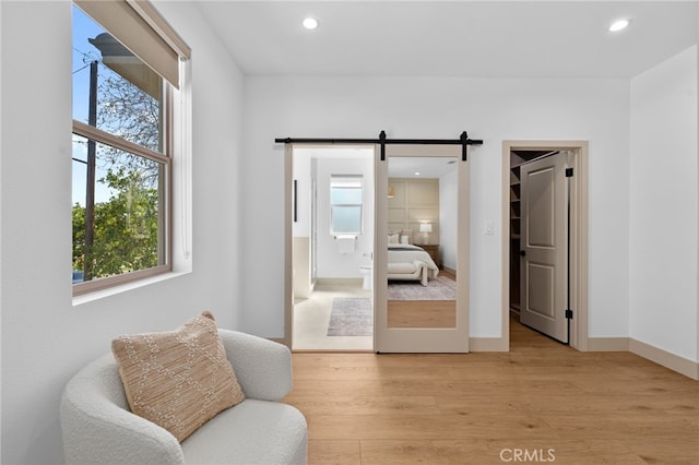16229 Orizaba Ave, Paramount, CA 90723 - living area featuring light wood-style flooring, a barn door, recessed lighting, and plenty of natural light