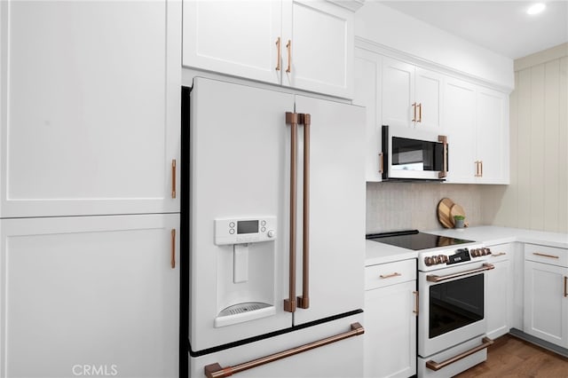 16229 Orizaba Ave, Paramount, CA 90723 - kitchen with white appliances, light countertops, white cabinets, decorative backsplash, and wood finished floors