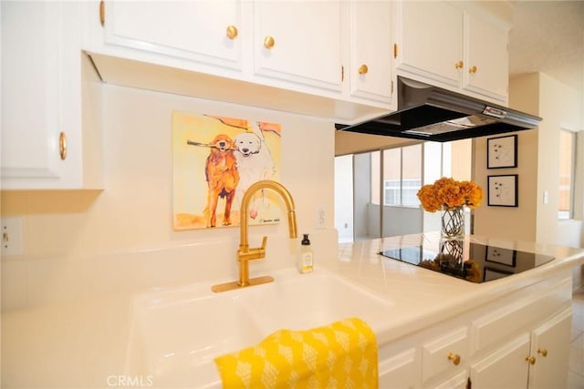 8710 Delgany Ave Unit 15, Playa Del Rey, CA 90293 - kitchen featuring under cabinet range hood, black electric stovetop, white cabinets, light countertops, and a peninsula