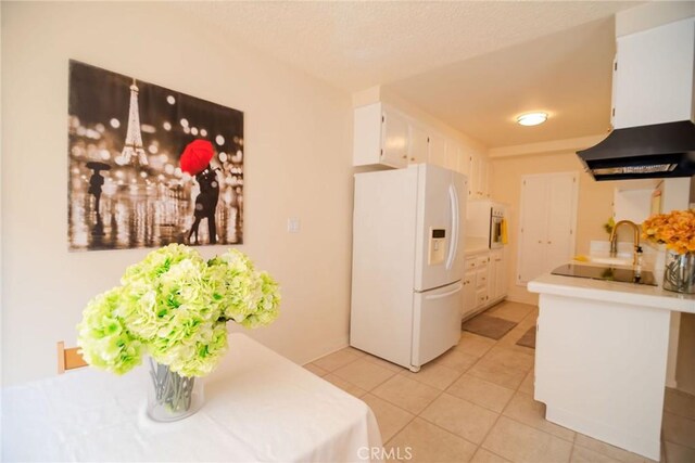 8710 Delgany Ave Unit 15, Playa Del Rey, CA 90293 - kitchen featuring white fridge with ice dispenser, white cabinets, light tile patterned floors, and light countertops