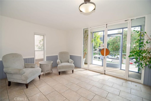 8710 Delgany Ave Unit 15, Playa Del Rey, CA 90293 - living area featuring a wainscoted wall and light tile patterned flooring