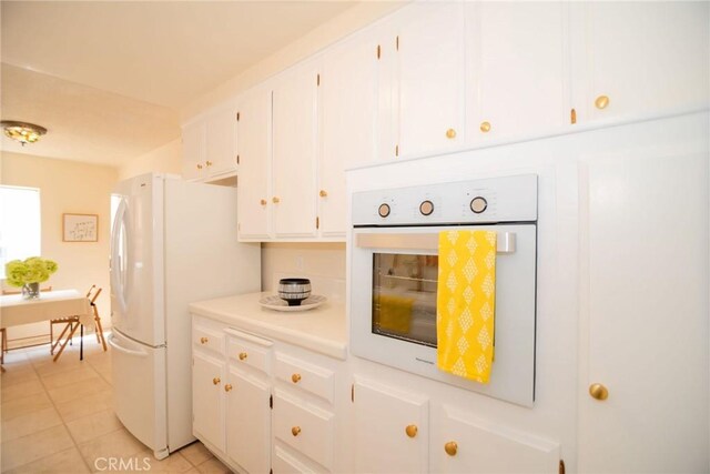 8710 Delgany Ave Unit 15, Playa Del Rey, CA 90293 - kitchen featuring white appliances, white cabinets, light countertops, and light tile patterned floors