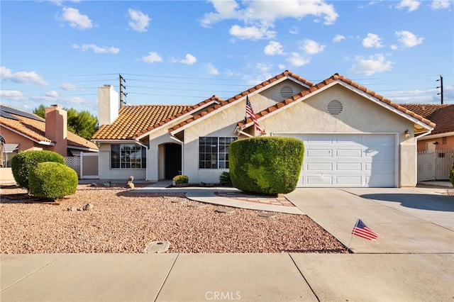 26293 Potomac Dr, Menifee, CA 92586 - mediterranean / spanish home featuring driveway, stucco siding, an attached garage, a tiled roof, and a chimney
