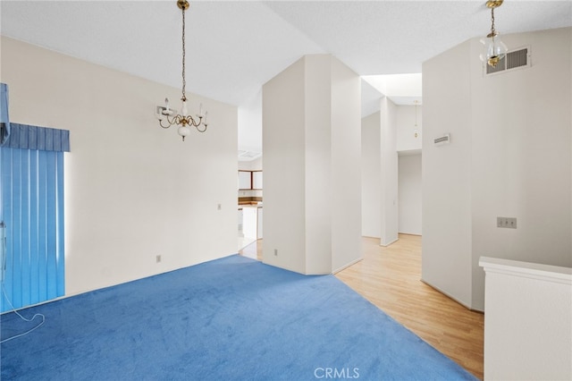 26293 Potomac Dr, Menifee, CA 92586 - unfurnished dining area with a chandelier, wood finished floors, and carpet