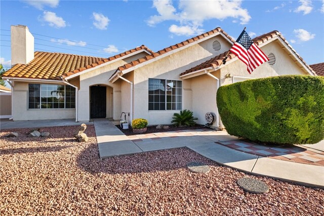 26293 Potomac Dr, Menifee, CA 92586 - mediterranean / spanish-style home featuring stucco siding, a chimney, and a tile roof