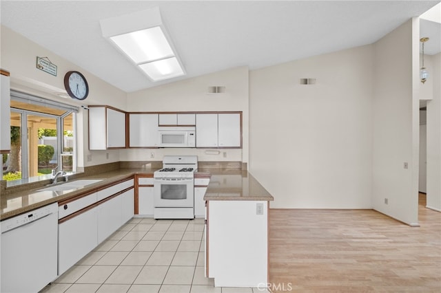 26293 Potomac Dr, Menifee, CA 92586 - kitchen featuring white appliances, vaulted ceiling, white cabinets, and a peninsula