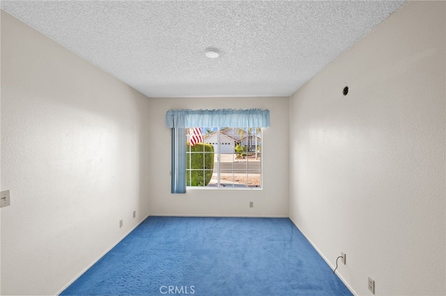 26293 Potomac Dr, Menifee, CA 92586 - empty room with carpet flooring, a textured ceiling, and a smoke detector