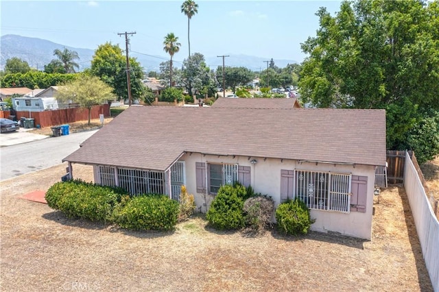 532 W 2nd St, Azusa, CA 91702 - rear view of property featuring stucco siding, roof with shingles, and a mountain view