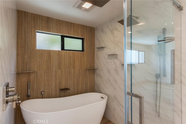 34693 Camino Capistrano Unit B, Dana Point, CA 92624 - full bathroom featuring a marble finish shower, plenty of natural light, tile walls, and a freestanding tub