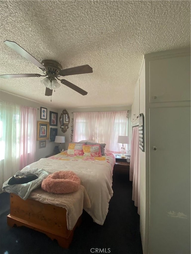 1210 7th Pl, Hermosa Beach, CA 90254 - bedroom with a textured ceiling, ceiling fan, and dark carpet