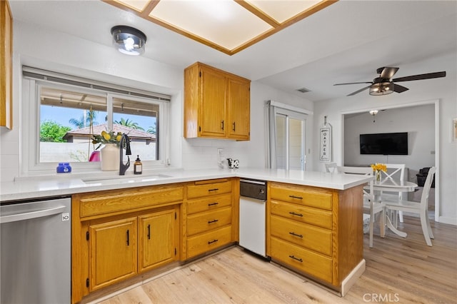 7009 Etter St, Bakersfield, CA 93308 - kitchen featuring stainless steel dishwasher, a peninsula, light wood-style flooring, and light countertops