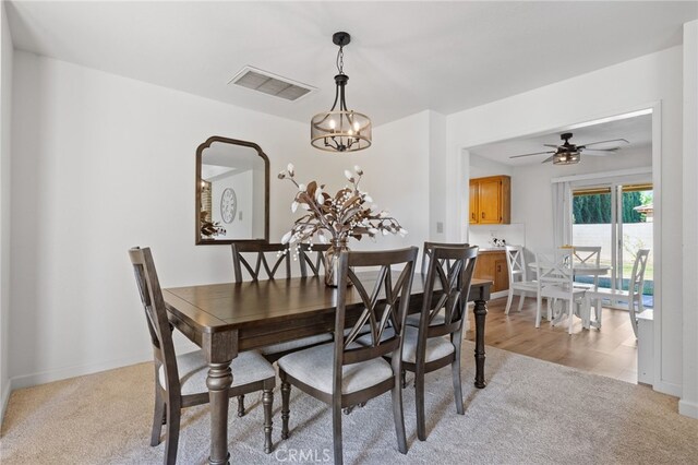 7009 Etter St, Bakersfield, CA 93308 - dining room with light colored carpet, a chandelier, and a ceiling fan
