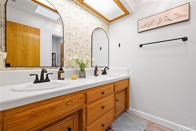 7009 Etter St, Bakersfield, CA 93308 - full bath with double vanity, wood finished floors, and wallpapered walls