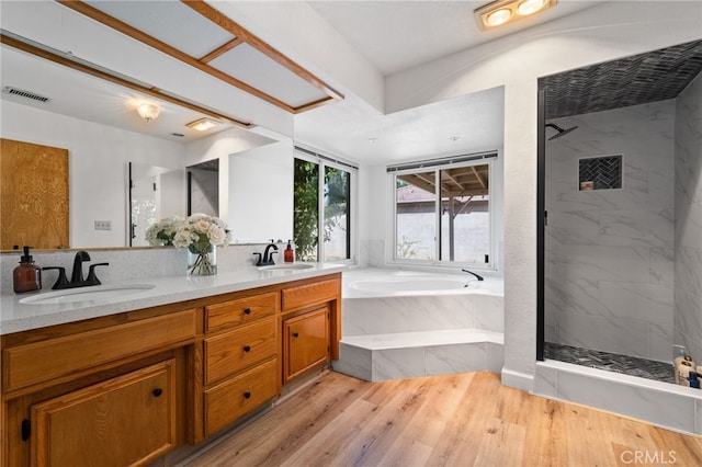 7009 Etter St, Bakersfield, CA 93308 - bathroom with a bath, double vanity, a marble finish shower, and wood finished floors