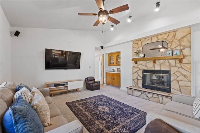 7009 Etter St, Bakersfield, CA 93308 - living area with a ceiling fan, light colored carpet, a fireplace, and vaulted ceiling