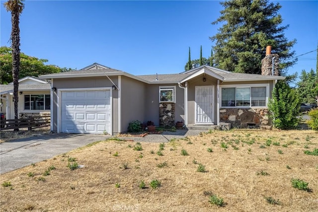 13169 Third St, Clearlake Oaks, CA 95423 - ranch-style home featuring a garage, asphalt driveway, a chimney, stone siding, and stucco siding