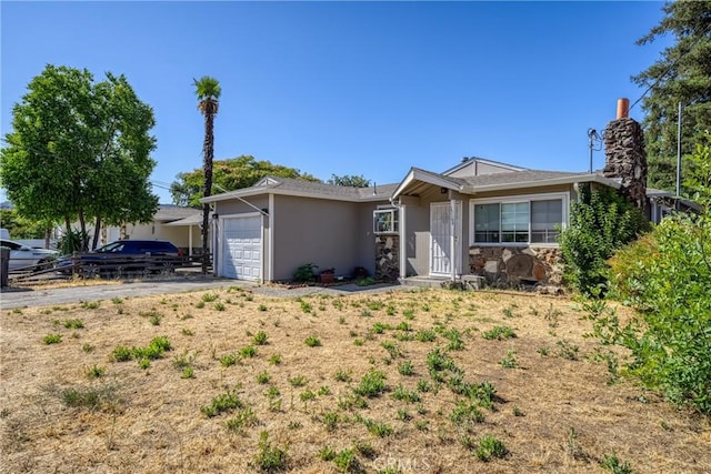 13169 Third St, Clearlake Oaks, CA 95423 - single story home with an attached garage, stucco siding, driveway, and stone siding