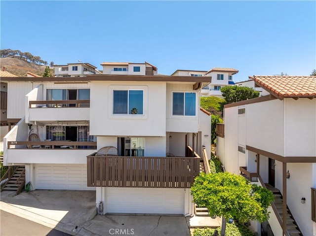 881 Calle Pluma, San Clemente, CA 92673 - back of property featuring a garage, stucco siding, driveway, and a tiled roof