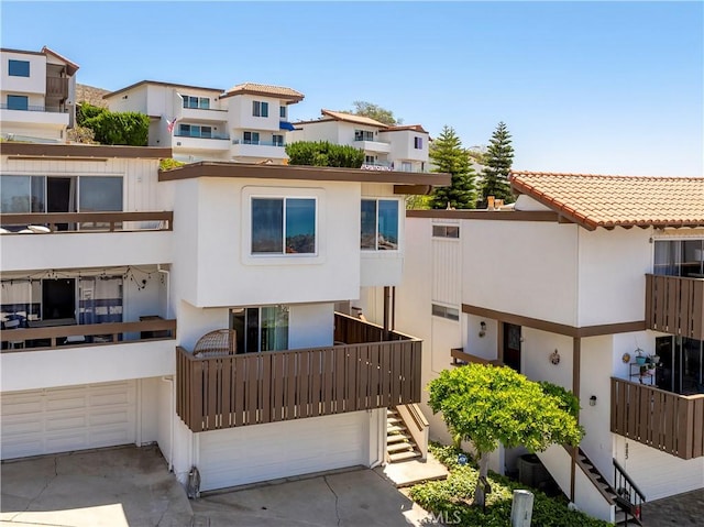 881 Calle Pluma, San Clemente, CA 92673 - view of front facade with stucco siding, an attached garage, and stairs