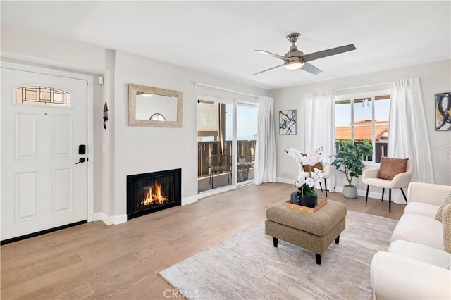 881 Calle Pluma, San Clemente, CA 92673 - living room with light wood-style floors, a lit fireplace, and ceiling fan