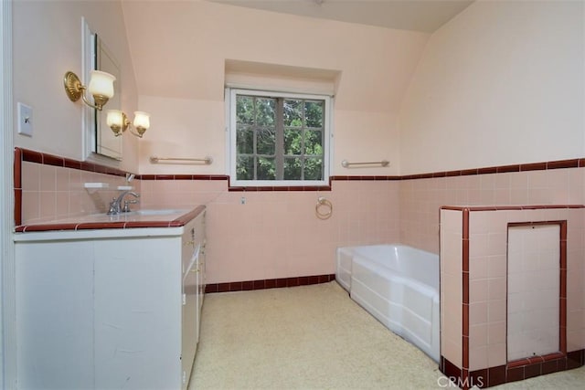 4312 Noble Ave, Sherman Oaks, CA 91403 - full bathroom with tile walls, vanity, a garden tub, and a wainscoted wall