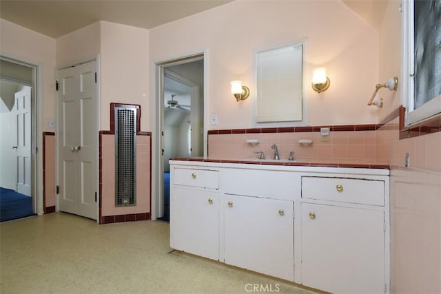 4312 Noble Ave, Sherman Oaks, CA 91403 - bathroom featuring ceiling fan, vanity, a wainscoted wall, and tile walls